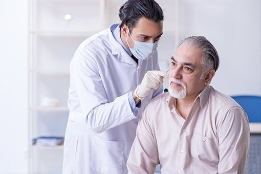 Doctor screen a patient for skin cancer.
