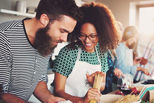 A couple cooking a meal together at a Cancer nutrition class.
