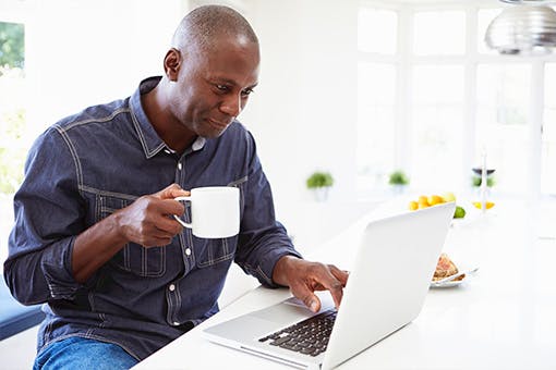 Man learning about cancer stages online.