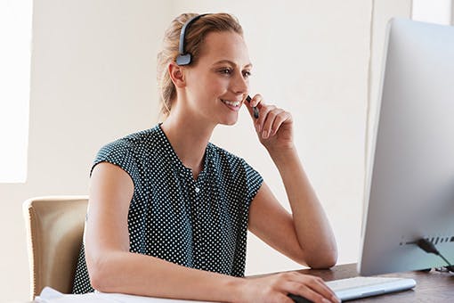 A nurse navigator supporting a patient on the phone and computer