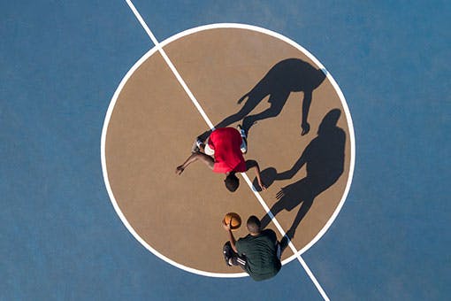 Two men playing basketball