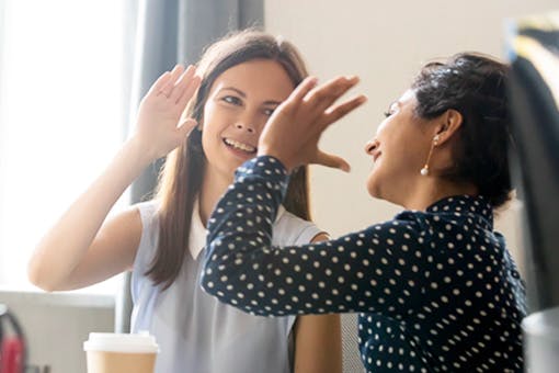 Woman giving a high five to her coach from the T2 Lifestyle Change Program for diabetes